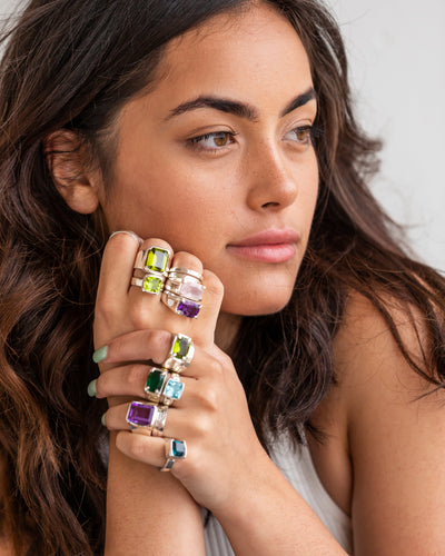 Hands wearing rings on different fingers, showcasing various ring placements for meanings
