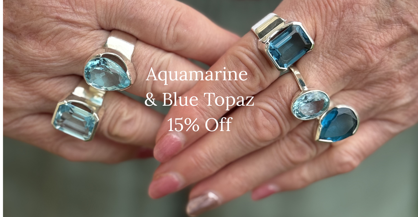 Two hands wearing aquamarine and blue topaz rings with promotional text overlay.